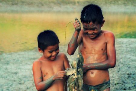 Children from the Bla’an tribe catching fish in a lake in South Cotabato, Philippines